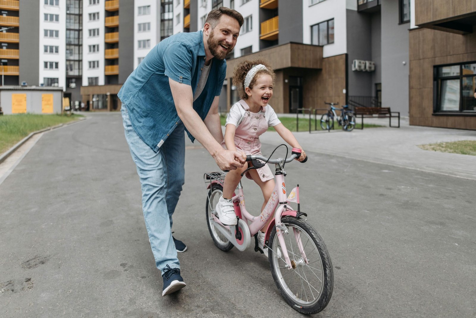 Father teaching daughter how to ride a bicycle - unbreakable fathership